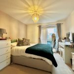 Cosy bedroom with double bed and decor.