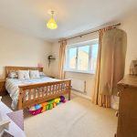 Cosy bedroom with a wooden bed and decor.