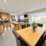 Spacious kitchen with wooden cabinets and dining area.