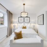 Modern white bedroom with ensuite bathroom.