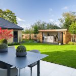 Modern garden with outdoor seating and shed.