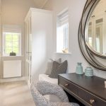 Elegant dressing room with mirror and stylish decor.