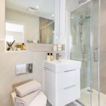 Modern bathroom with shower and vanity unit.