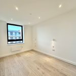 Empty room with wooden floor and window.