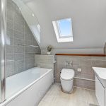 Modern bathroom with skylight and bathtub