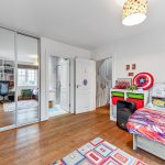 Colourful child's bedroom with books and toys.