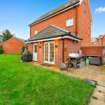 Brick house with garden and patio area