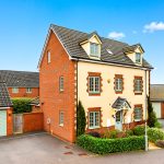 Modern detached house with garages in residential area.