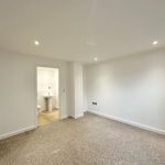 Empty room with doorway and carpeted floor