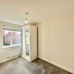 Empty room with carpet and mirrored wardrobe