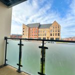 View from balcony overlooking modern residential buildings.