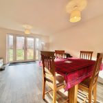 Bright dining room with wooden table and chairs.
