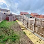 Back garden with shed and wooden fences.