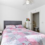 Cosy bedroom with colourful bedspread.