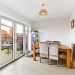 Bright dining room with garden view and wooden table.