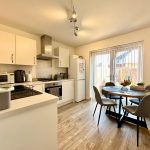 Modern kitchen with dining table and appliances