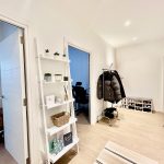 Bright hallway with coat rack and bookshelf