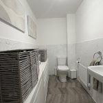 Minimalist modern bathroom with wicker baskets.
