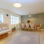 Modern dining room with elegant decor and table setting.