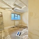 Empty room with peeling paint and ladder.