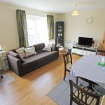 Bright living room with sofa and dining table.
