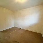 Empty room with cupboard and bare floor.