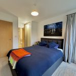 Modern bedroom with double bed and artwork