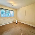 Empty room with tiled floor and window.