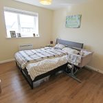 Cosy bedroom with bed and bedside cot