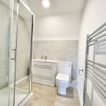 Modern bathroom with shower and towel rail