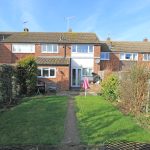 Brick house with garden on sunny day