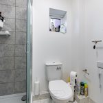 Modern bathroom with shower and toilet.