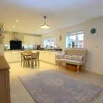 Spacious modern kitchen with dining area and decor.