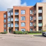Modern brick apartment building exterior with balconies
