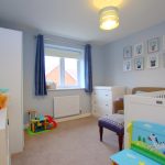 Bright nursery with toys and animal-themed decor.