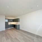 Modern empty kitchen with hardwood floor.