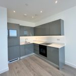 Modern kitchen with grey cabinets and sleek design.