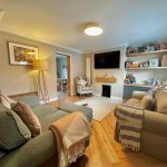 Cosy living room with modern decor and TV.