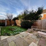 Suburban patio with garden and outdoor seating.
