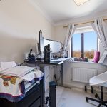 Home office with desk, chair, and computer setup.