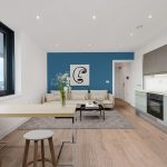 Modern kitchen and living room design with blue accent.