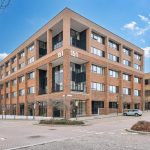 Modern brick office building on a sunny day.