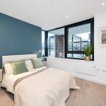 Modern bedroom with blue accent wall and decor