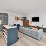 Modern open-plan apartment living area and kitchen.