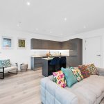 Modern open-plan kitchen and lounge with colourful decor.