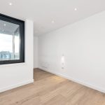 Modern room with large window and wooden floor