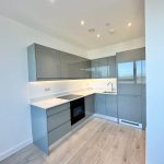 Modern grey kitchen with wooden floor
