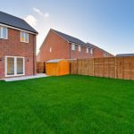 Back garden with shed and brick house