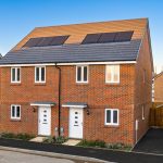 Modern semi-detached brick houses with solar panels.