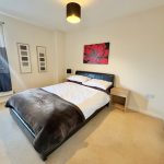 Cosy bedroom with double bed and modern decor.